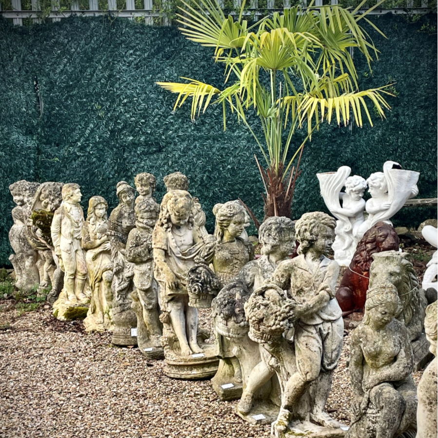 A charming collection of vintage and weathered garden statues.