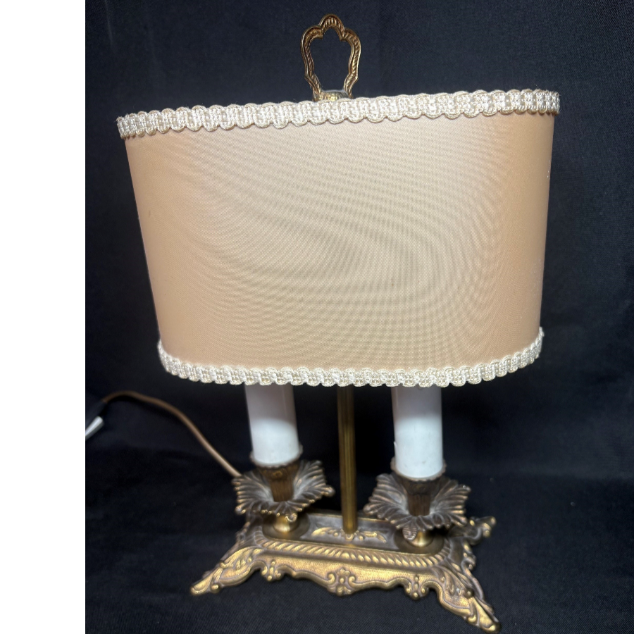 Vintage two-light bouillotte table lamp featuring an ornate brass candlestick base and an oval peach fabric shade - VIN813F Vintage two-light bouillotte table lamp featuring an ornate brass candlestick base and an oval peach fabric shade - VIN813F
